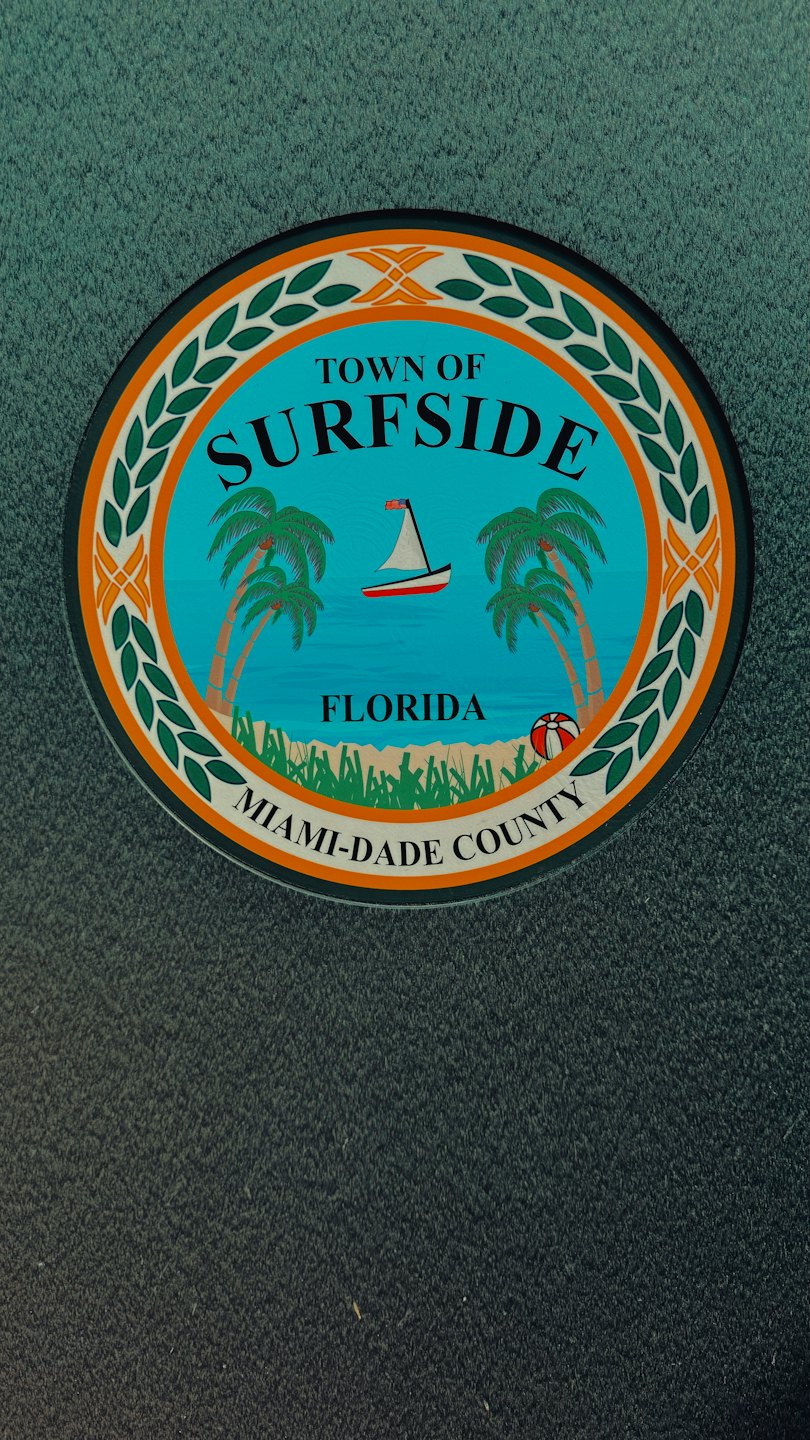 Official Town of Surfside emblem featuring a beach scene.